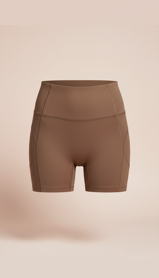 High-waisted sculpting shorts in mocha chic, Hero product shots at three-quarter angle on torso mannequins or live models;...